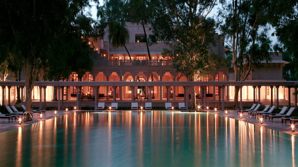 Amanbagh swimming pool lit in the evening 