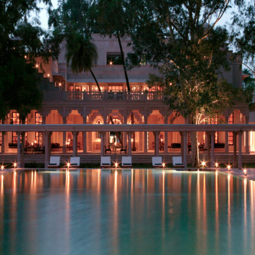 Amanbagh swimming pool lit in the evening