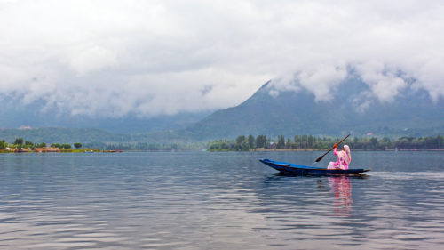 Man in a boat on Dal Lake in Kashmir