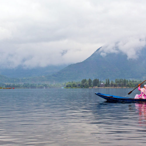 Man in a boat on Dal Lake in Kashmir