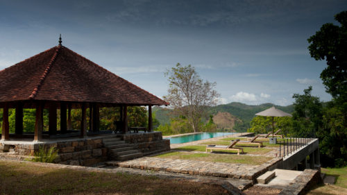 Outdoor pool and lounge area at Koslanda