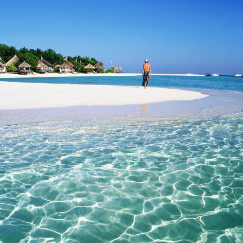 Greaves India Maldives woman walking on a beautiful beach