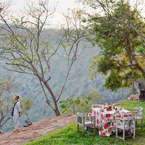 Woman standing on hilltop in Safronsandalwood, India