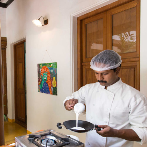 Indian man making pancakes