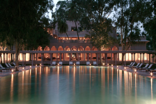 Amanbagh swimming pool lit in the evening