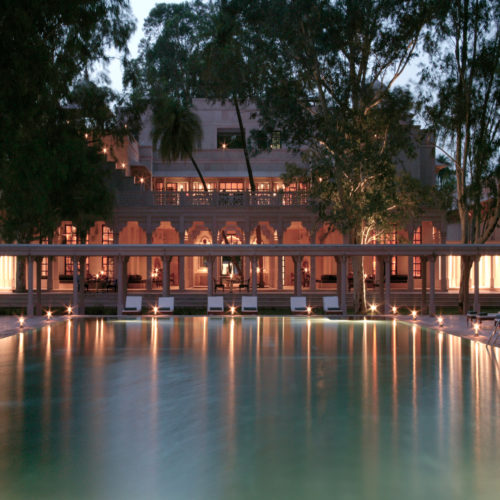 Amanbagh swimming pool lit in the evening