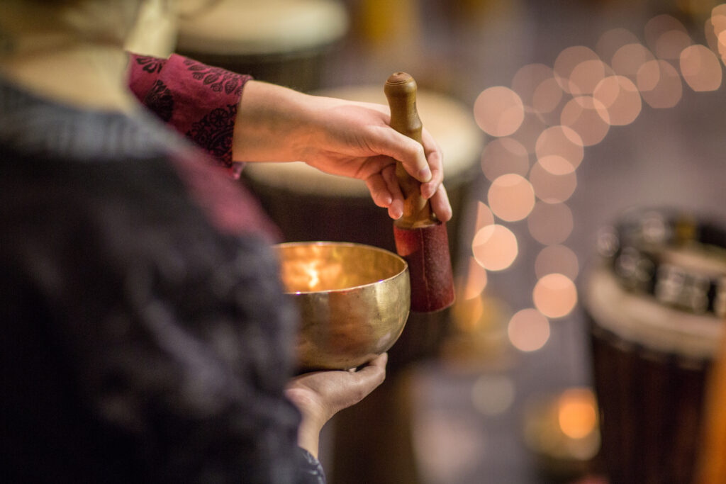 Woman using a Tibetian singing bowl